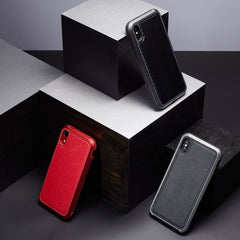 Three smartphone cases, including the Raptic iPhone XR Case - LUX, are showcased on geometric black and gray blocks. Made from impact-resistant polycarbonate, these cases come in vibrant red, sleek black, and modern gray hues.