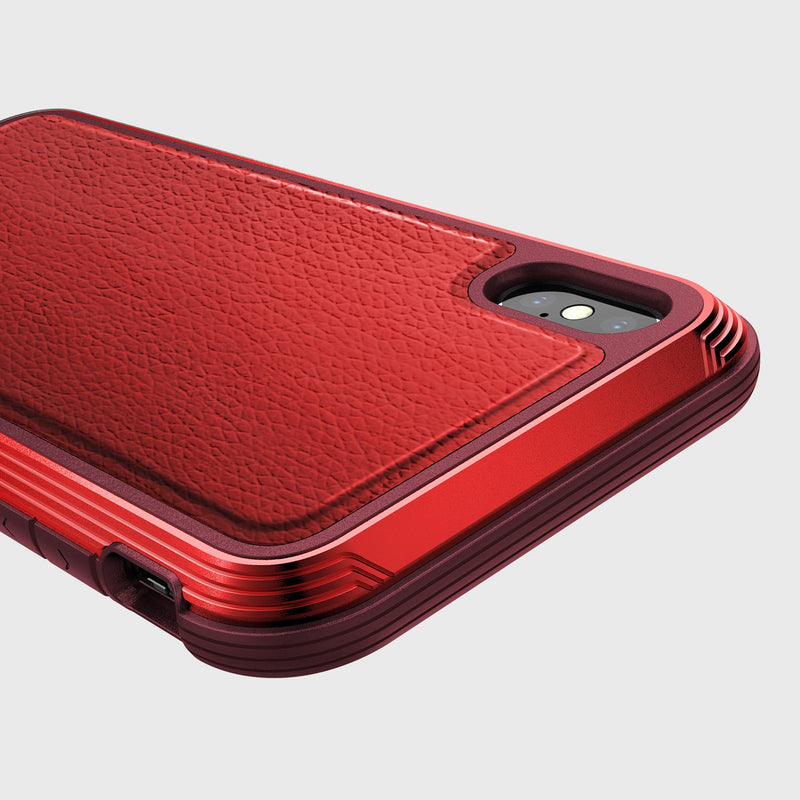 Raptic's iPhone XS Max Case - LUX features a textured leather-like back and ridged edges, shown partially covering the phone on a plain background.