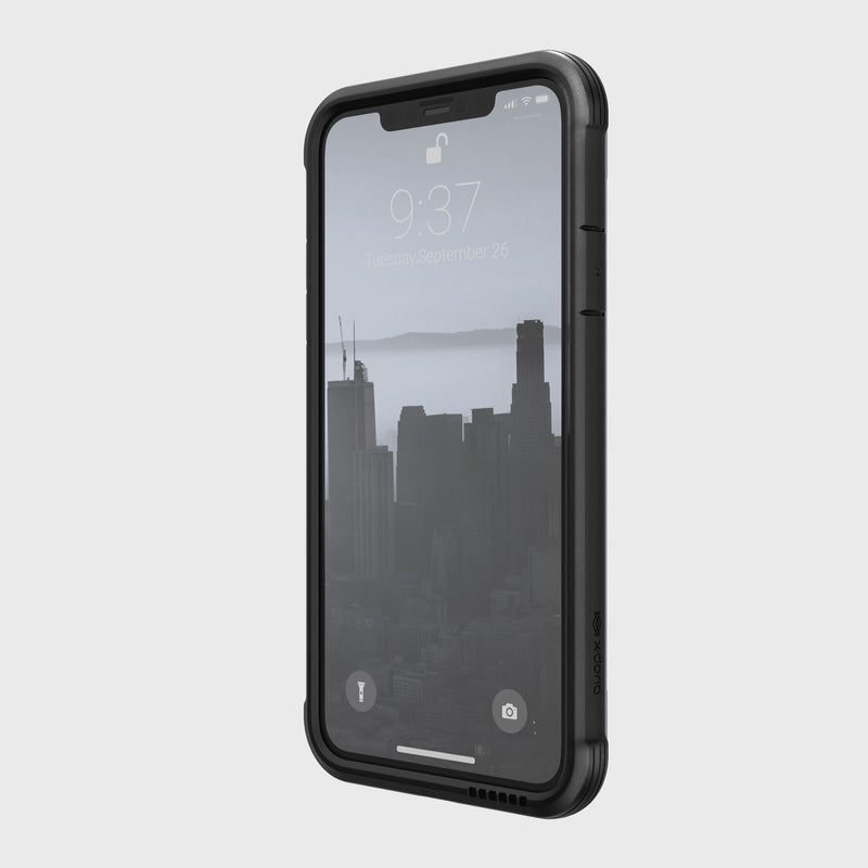 The Raptic SHIELD black case offers robust protection for the iPhone 11. The phone lock screen displays 9:37 over a cityscape background and supports wireless charging for convenience.