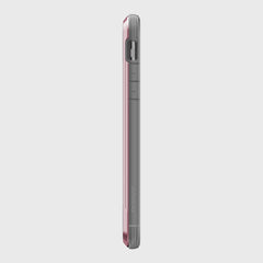 This side view of an iPhone 11 Pro elegantly showcases the Raptic SHIELD case in red and gray, featuring precise volume buttons and a camera cutout. Its sleek design ensures ultimate protection, is wireless charging compatible, all set against a crisp white background.
