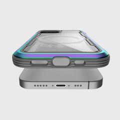 The Raptic SHIELD PRO MAGNET case for iPhone 12 & 12 Pro features a multi-colored edge, transparent back, and circular cutout. Designed for MagSafe chargers, it offers easy access to the charging port and speaker grilles while ensuring reliable drop protection.