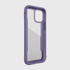 The iPhone 12 Raptic Shield case in purple by Raptic features a transparent back and a machined aluminum bumper. It's designed for dual-lens camera smartphones and supports wireless charging.