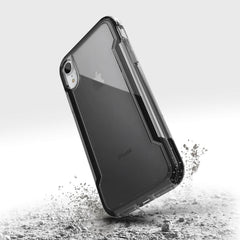 The back of a Raptic iPhone XR Case - CLEAR with sand on it.