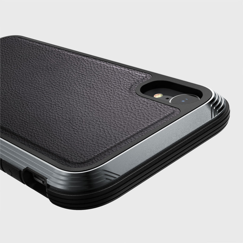 Close-up of an iPhone XR Case - LUX by Raptic, showcasing a textured black impact-resistant polycarbonate back with a metallic gray edge, highlighting the camera lens and flash.
