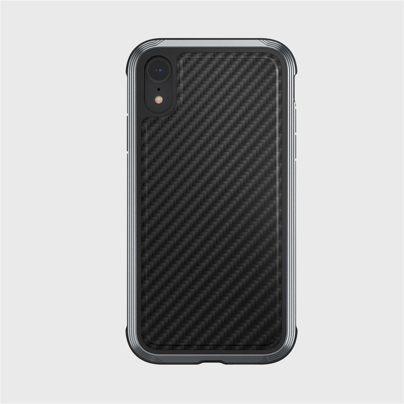 The smartphone, set against a plain gray backdrop, is encased in the striking Raptic LUX iPhone XR case with a black carbon fiber pattern. It has an impact-resistant polycarbonate build and features a single rear camera and flash.