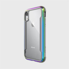 A smartphone with the Raptic SHIELD transparent iPhone XR case, featuring iridescent edges and highlighting the Apple logo and dual camera, provides military-grade drop protection with advanced shock absorption.
