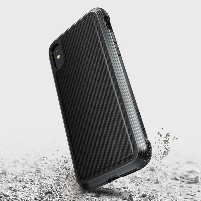 The iPhone XS Max Case - LUX by Raptic is shown on a gray background. This black protective case features a rugged, impact-resistant polycarbonate design with a textured surface.