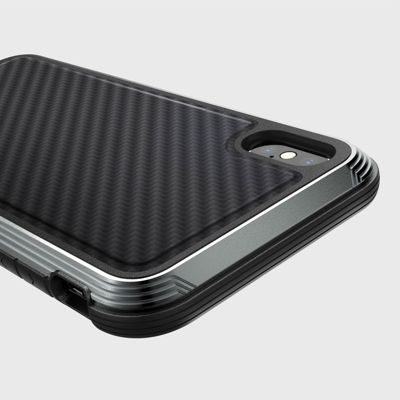 Close-up of Raptic's iPhone XS Max Case - LUX, featuring a textured carbon fiber finish with visible camera and flash, metallic accents, and impact-resistant polycarbonate for durable protection.