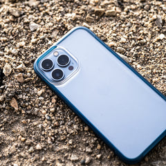 An eco-friendly iPhone 13 Pro Case - TERRAIN by Raptic laying on the ground.