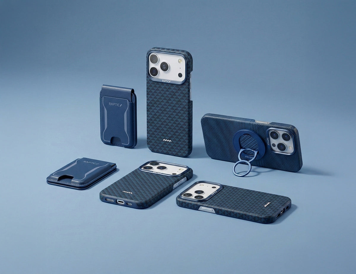 A variety of Raptic-branded phone cases and accessories are arranged on top of technical sketches and architectural plans, with pencils and a color wheel nearby.