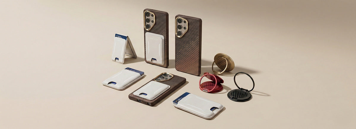Several smartphones with textured brown cases stand upright or lie flat, each fitted with a white attachable wallet. Other accessories, including mounts and rings, are arranged around them.