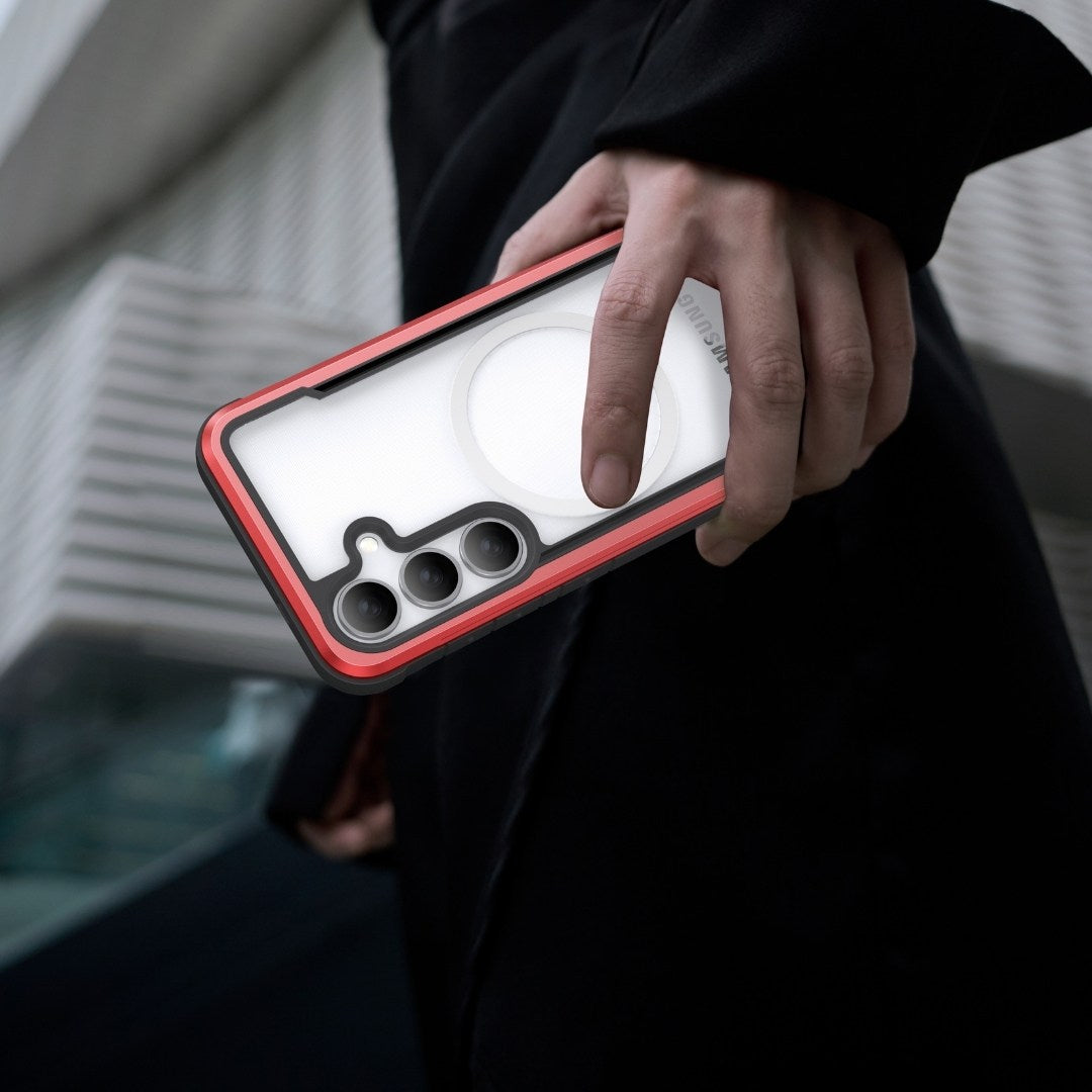 A hand holds a Samsung Galaxy S25 with a distinctive circular rear design inside a Raptic SHIELD case. The phone features military-grade drop protection, an elegant red border, and antimicrobial treatment for enhanced security and hygiene.