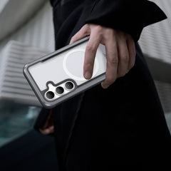 A person holds a Raptic Samsung Galaxy S25 Case - SHIELD, designed for military-grade drop protection, highlighting its multiple camera lenses against a modern architectural backdrop.