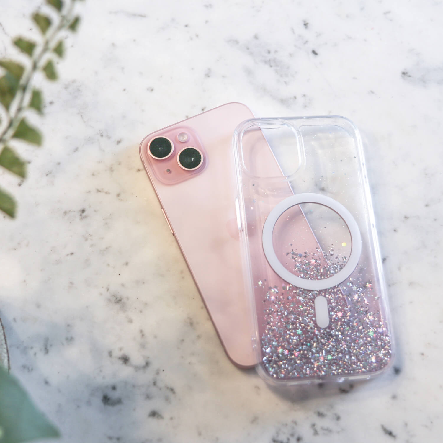 A pink iPhone 15 Starburst Glitter MagSafe Case - Bryten by Raptic with a flower on it.