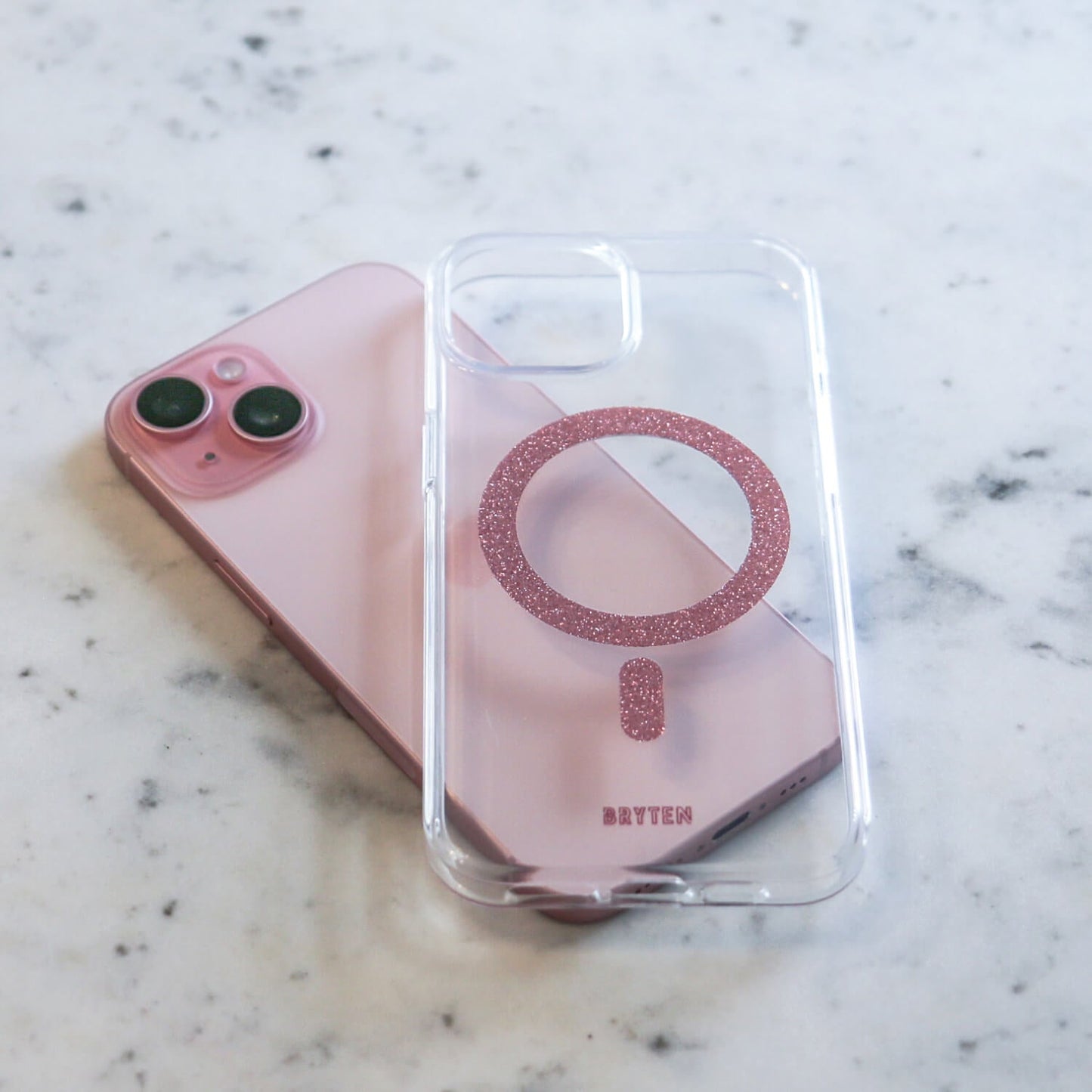 A pink iPhone 15 MagFx MagSafe Case - Bryten by Raptic with a magnifying glass on it, enhanced with MagFx technology.