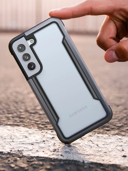 A person holding a Raptic drop protection case for the Samsung Galaxy S22 - SHIELD.