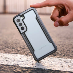 A person holding a Raptic drop protection case for the Samsung Galaxy S22 - SHIELD.