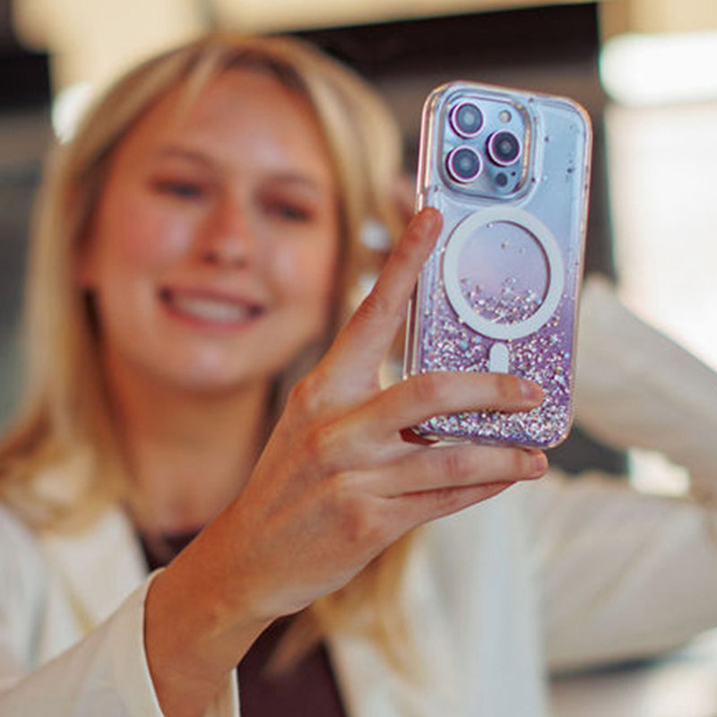 A woman is taking a picture of her iPhone 15 Starburst Glitter MagSafe Case - Bryten by Raptic with MagSafe technology for wireless charging capabilities.