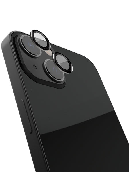 A black iPhone 15 with a Raptic Armour camera protector and three Raptic lenses on it.