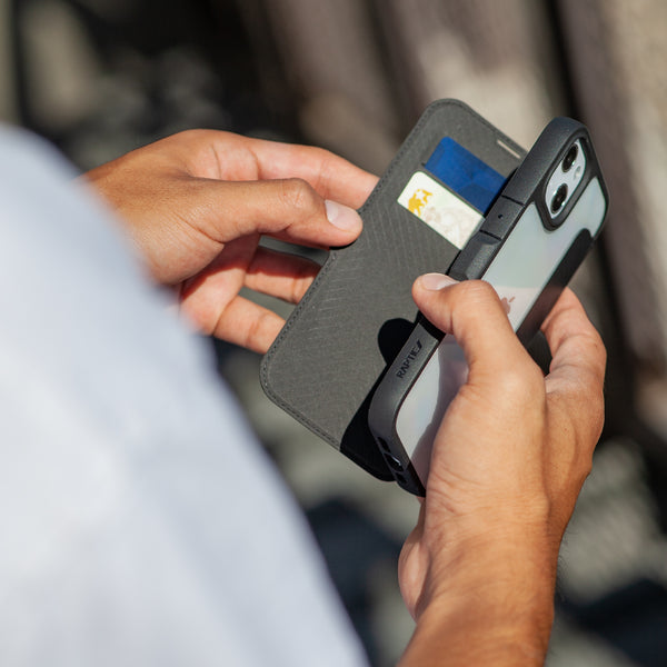 A person showcasing the Raptic Urban Folio iPhone 13 Pro Leather Folio Case - Urban that meets Military Grade Drop Test standards, featuring MagSafe compatibility.