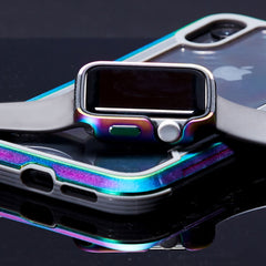 A Raptic Apple Watch 40mm with a rainbow anodized aluminum case and black band rests on a smartphone with an identical case. Both gleam on the reflective black surface, combining style and scratch protection.