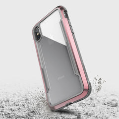 The iPhone XS Max Case - SHIELD by Raptic in pink and grey offers drop protection.