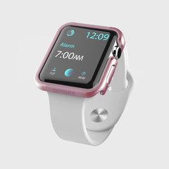 A white-banded Apple Watch 40mm Case - EDGE by Raptic shows an alarm for 7:00 AM and a time of 12:09. The watch case has a pink tint with anodized aluminum for durability.
