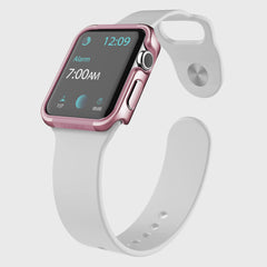 The Raptic Apple Watch 40mm Case - EDGE features a pink bezel and white band, crafted from anodized aluminum for durability. Its display currently shows 12:09, with an alarm set for 7:00 AM. Equipped with scratch protection, it combines everyday resilience with elegance.