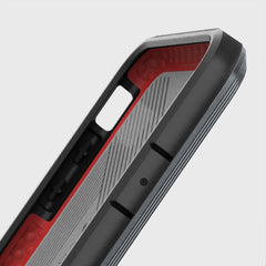 The back view of a protective X-Doria iPhone Xs Defense Ultra Black case with red and black accents.