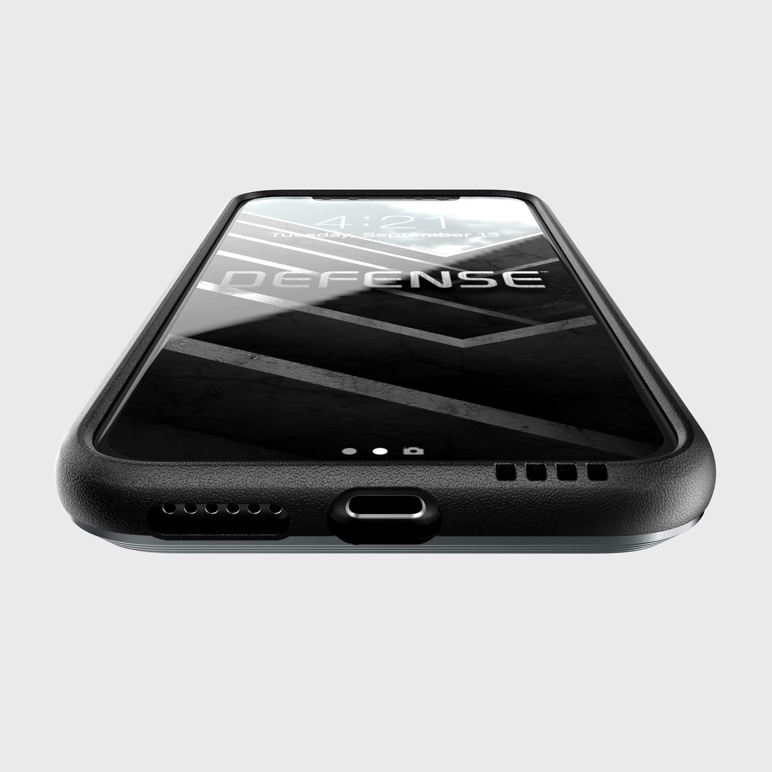 A phone with a black X-Doria iPhone Xs Defense Ultra Black case that provides device protection according to the MIL-STD-810G Standard.