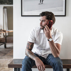 A man sitting on a bench talking on his Raptic iPhone 11 Pro Max Case - AIR.
