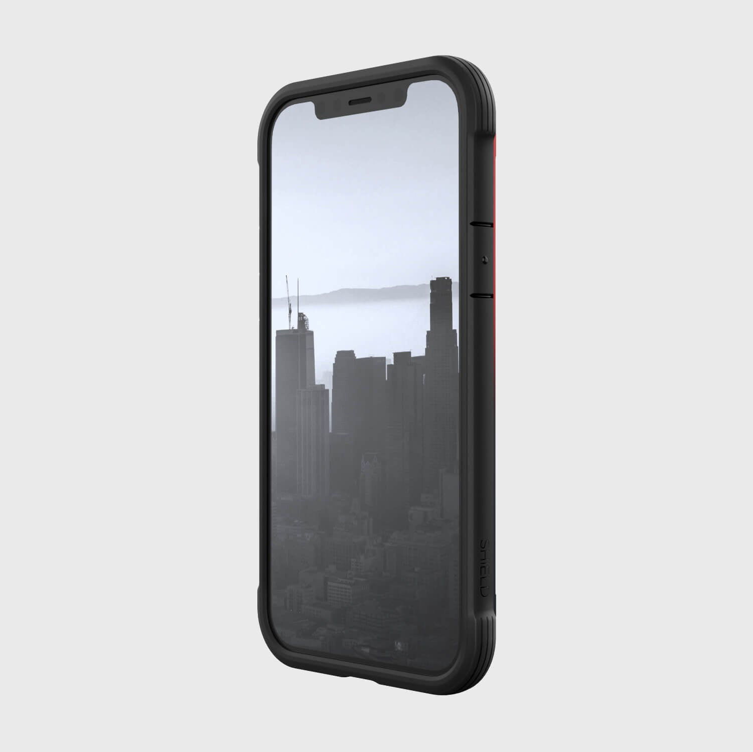 A black Raptic iPhone 12 & iPhone 12 Pro Case - SHIELD providing protection with a view of the city.
