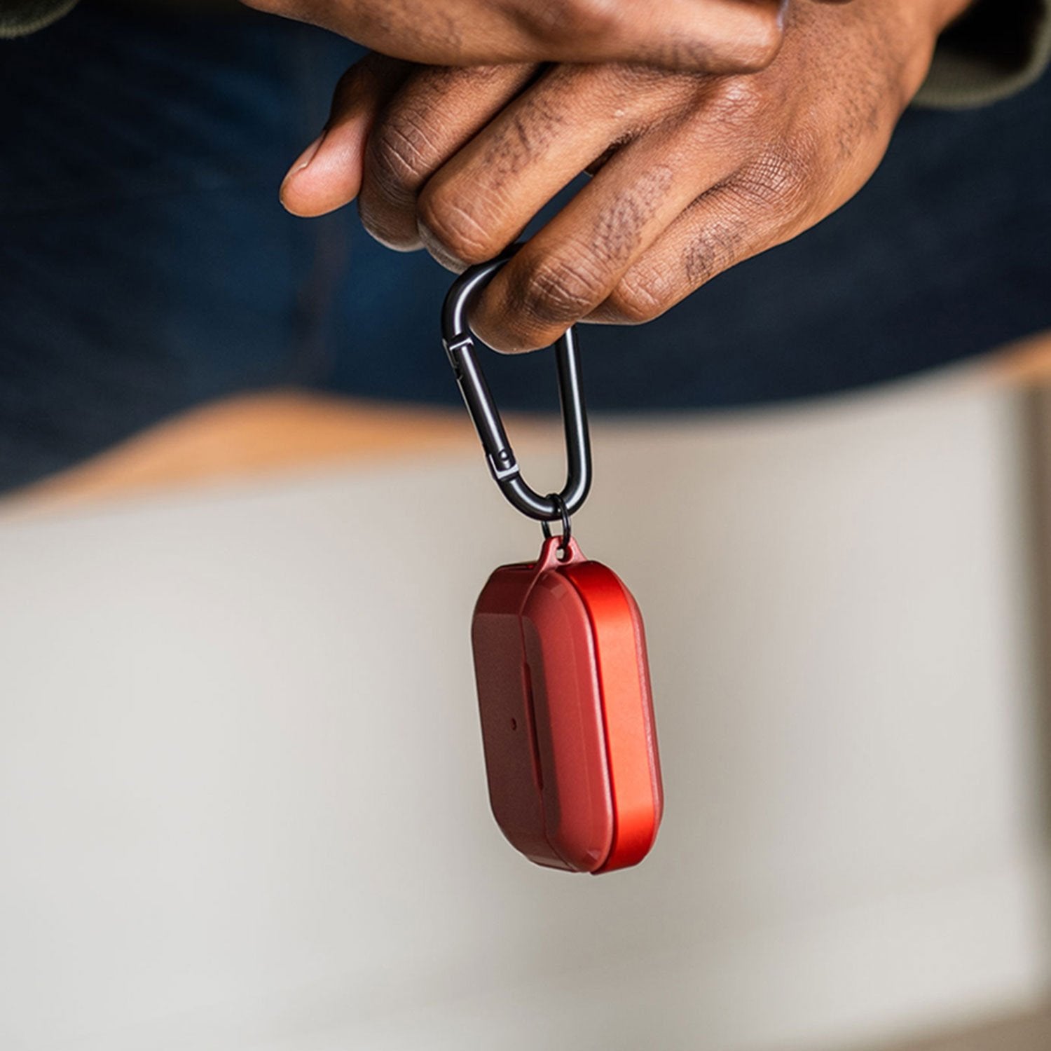 Raptic Trek Red on Apple AirPods Pro showing the easy to slip on and off top, bottom and detachable carabiner.