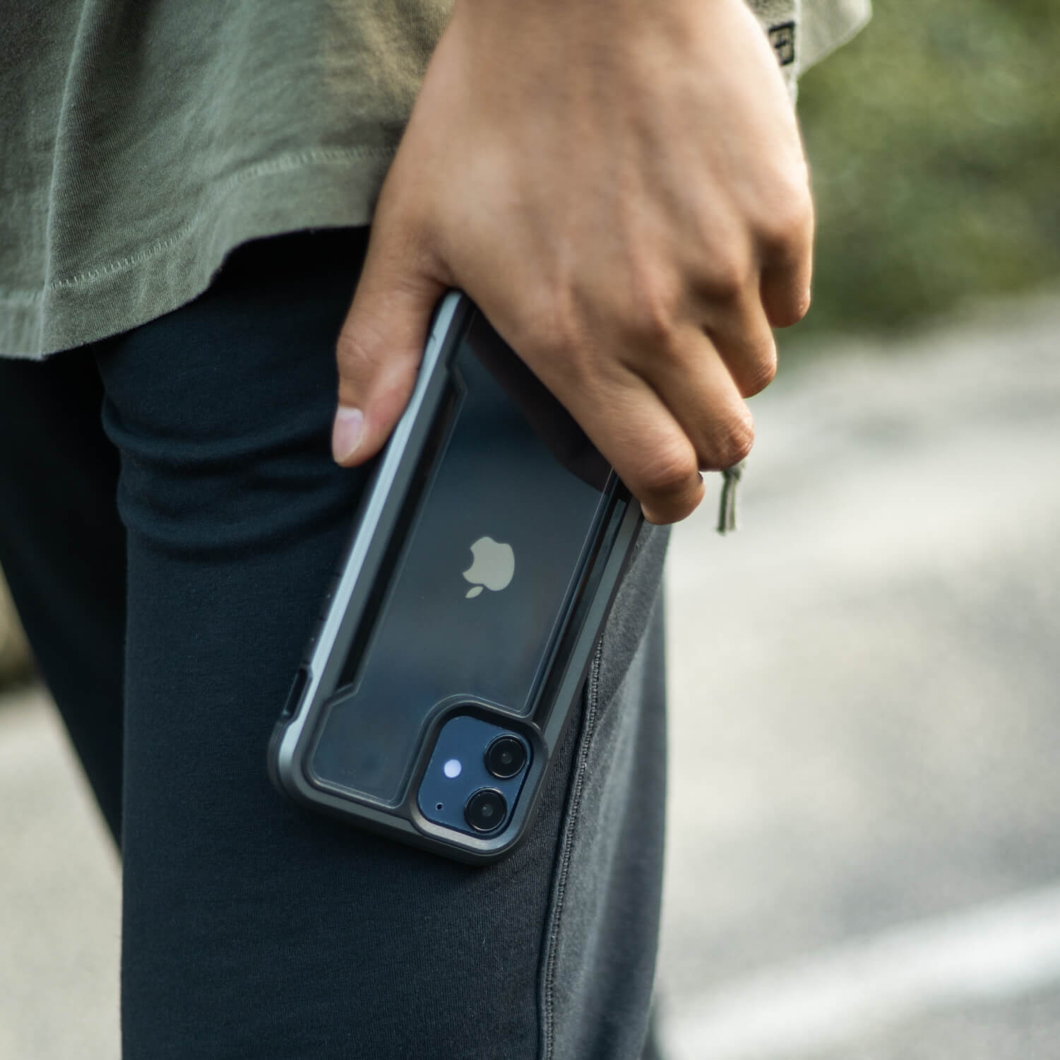 A person holding an iPhone 12 Mini Case - SHIELD by Raptic in their hands.