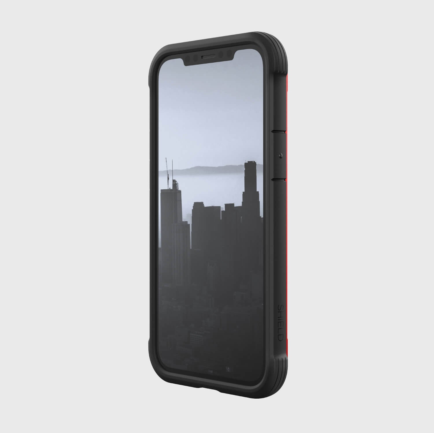 A black and red iPhone 12 Mini Case - SHIELD by Raptic with a view of the city.
