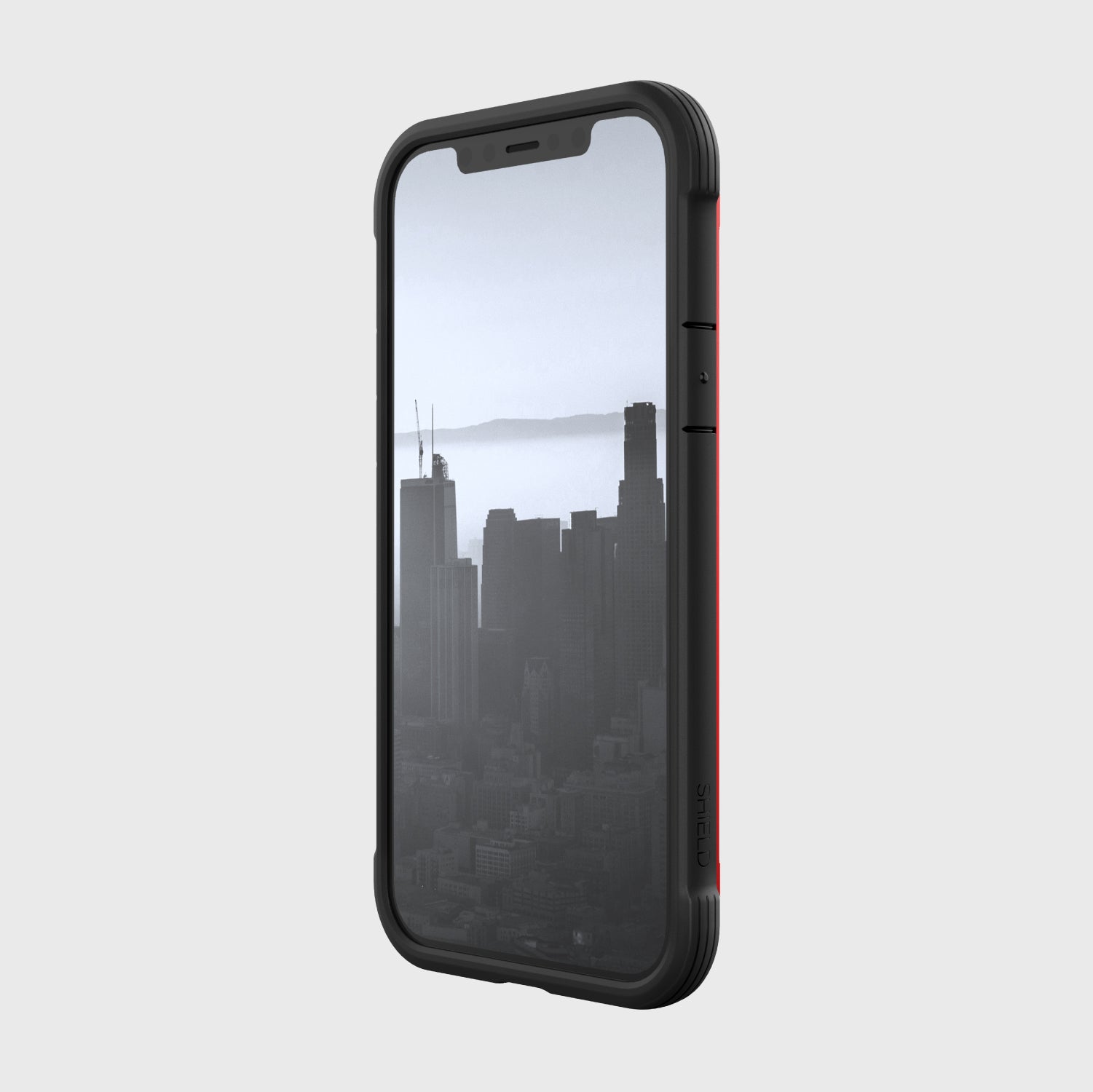 A black and red Raptic SHIELD case with a view of the city, providing 13' foot drop protection for iPhone 12 Pro Max.