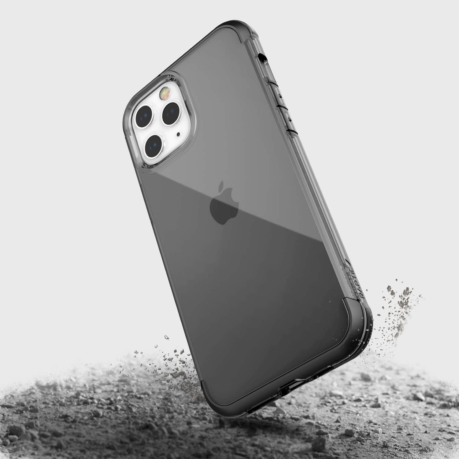 A black Raptic iPhone 13 Pro case with sand on it, offering wireless charging compatibility.