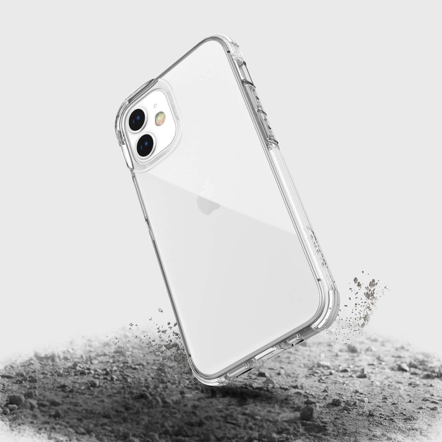A Raptic Clear iPhone 12 Mini case with sand on it, offering wireless charging compatibility and 2-metre drop protection.