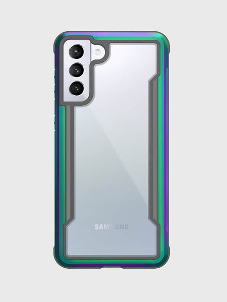 The X-Doria Samsung Galaxy S21 Case Raptic Shield Iridescent elegantly frames the phone with a clear design and green-purple border, highlighting its three rear cameras. Compatible with wireless charging and offering military-grade protection, it provides peace of mind against a gray backdrop.