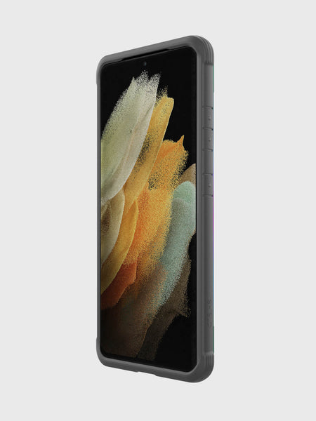 A Samsung Galaxy S21 Ultra with an X-Doria Raptic Shield Iridescent case and abstract wallpaper is angled against a plain light gray background, showcasing its military-grade drop protection.