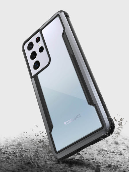 A drop protection phone case for Samsung Galaxy S21 Ultra, the X-Doria Samsung Galaxy S21 Ultra Case Raptic Shield Black with a camera on it.