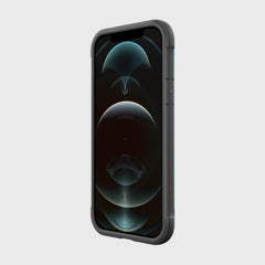 The sleek black Raptic SHIELD PRO MAGNET case for iPhone 12/Pro, with an abstract dark circular wallpaper, stands against a light gray backdrop. Designed for durability, it provides drop protection and is compatible with MagSafe chargers for seamless everyday use.