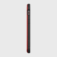 Side view of an iPhone 12 in a red and black SHIELD PRO MAGNET case by Raptic, highlighting buttons and speaker. This rugged iPhone 12 & iPhone 12 Pro case is designed for superior drop protection and integrates seamlessly with MagSafe chargers.