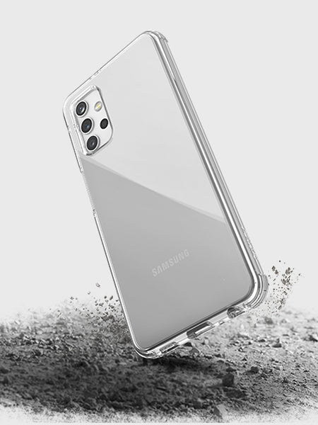 The X-Doria Samsung Galaxy A32 5G Case Raptic Clear shields your Samsung smartphone as it hits a rugged surface, with dust and debris dispersing—showcasing the military-grade drop protection provided by this case.