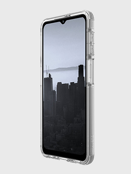 A Samsung Galaxy A32 5G showcases a grayscale cityscape wallpaper with tall buildings shrouded in mist, protected by the X-Doria Raptic Clear case. This case blends sleek transparency with military-grade drop protection, ensuring ultimate peace of mind.