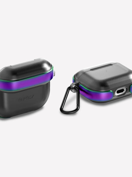 Two black Raptic Strong protective AIR cases for AirPods 3, compatible with wireless charging, feature iridescent purple and green edges. One case is open; the other is closed with a detachable carabiner.