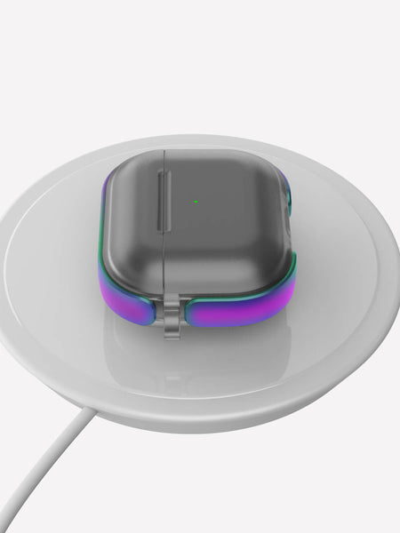 A Raptic Strong Apple AirPods 3 Case in dark gray with purple accents rests perfectly on a round white wireless charging pad, showcasing its wireless compatibility.