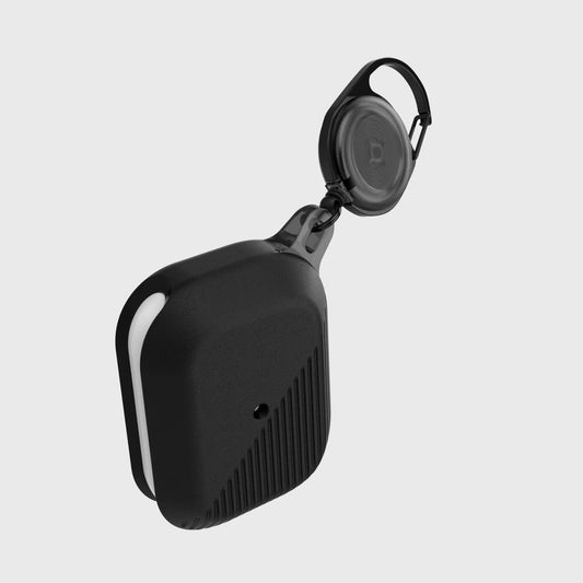 A small black silicone Raptic device with a carabiner clip attached to it for protection; specifically, the Apple AirPods Pro Case - RADIUS.
