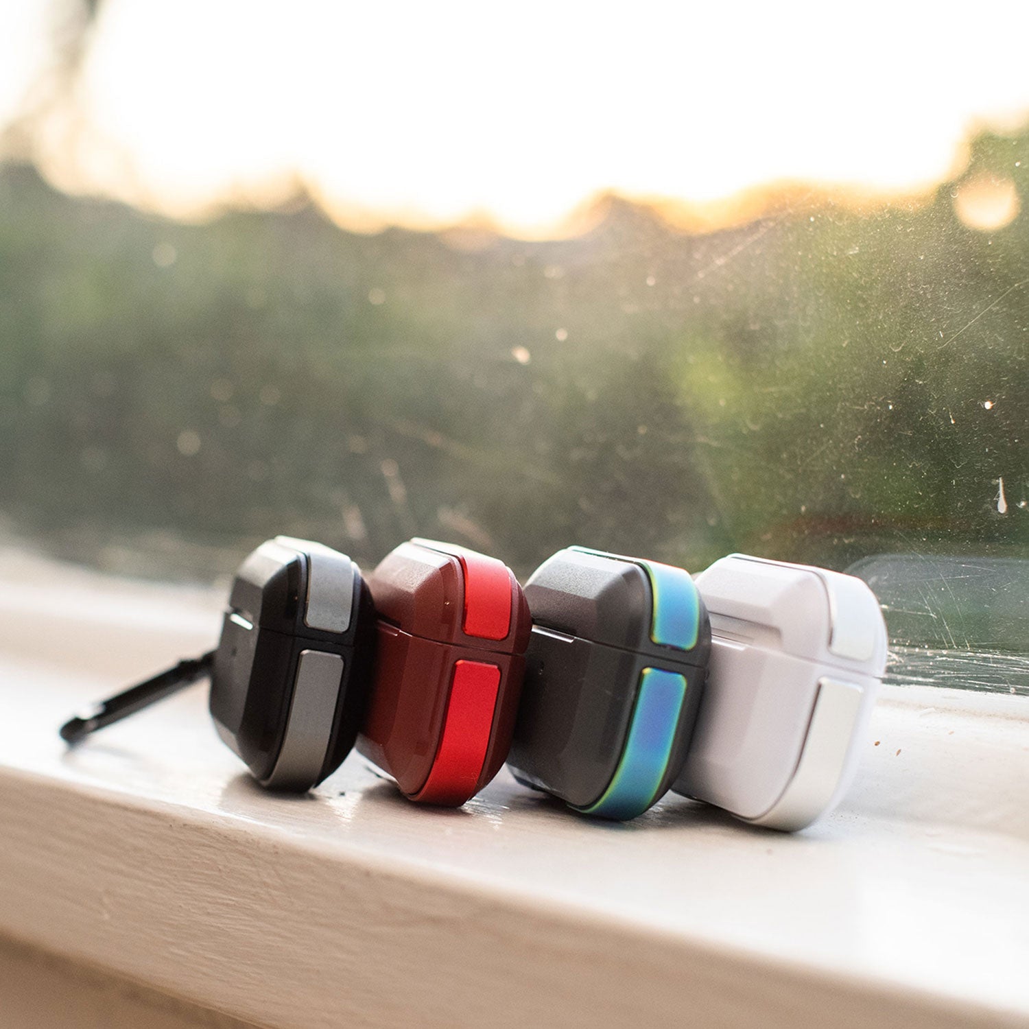 Raptic Apple AirPods Pro Case - TREK wireless charging earbuds sitting on a window sill.