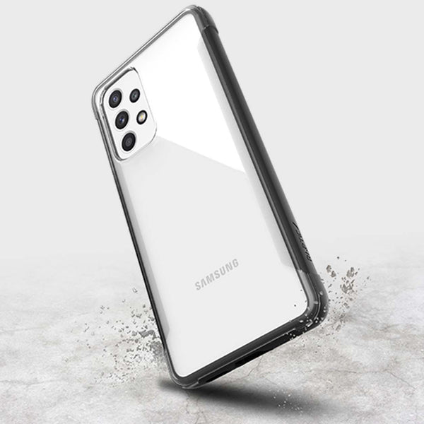 A Raptic Strong Samsung Galaxy A53 smartphone with a reflective back and quad-camera setup, encased in a Raptic EARTH eco-friendly, biodegradable protective cover, levitating above a concrete surface with a slight splash effect.